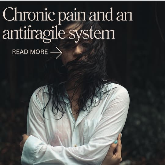 Woman holding arms wrapped around body Title: Chronic pain and an antifragile system